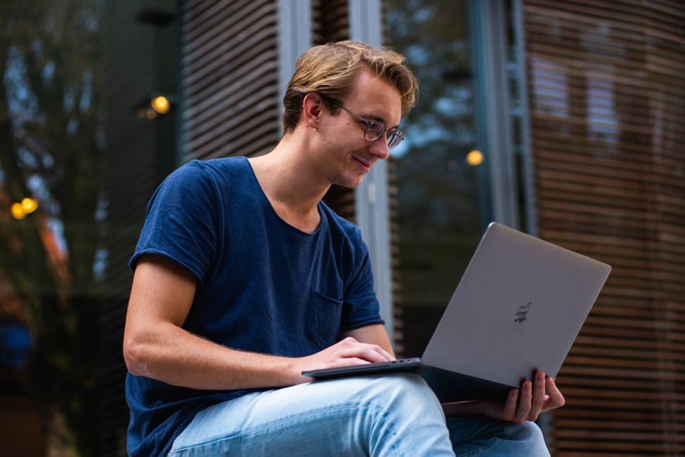 Man Sitting Outside on a Laptop